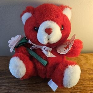 Charming Red and White Stuffed Bear Holding A Pink Flower And Ribbon Around Neck